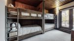 Second bedroom offers two bunks, balcony access, ski locker and en suite bathroom